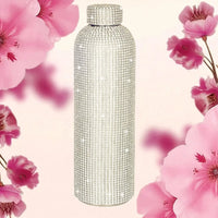 Sparkling crystal-encrusted water bottle with pink floral backdrop, luxury home decor accessory