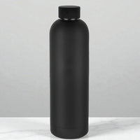 Matte black insulated water bottle on marble surface, modern home accessory
