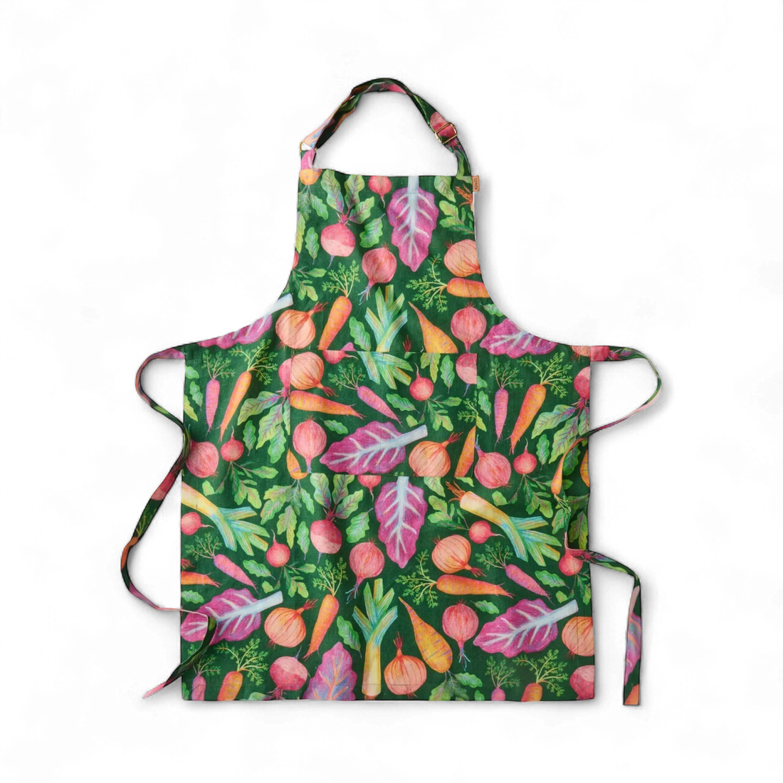 Colorful vegetable print apron with carrots, beets, and onions on green background, perfect kitchen décor