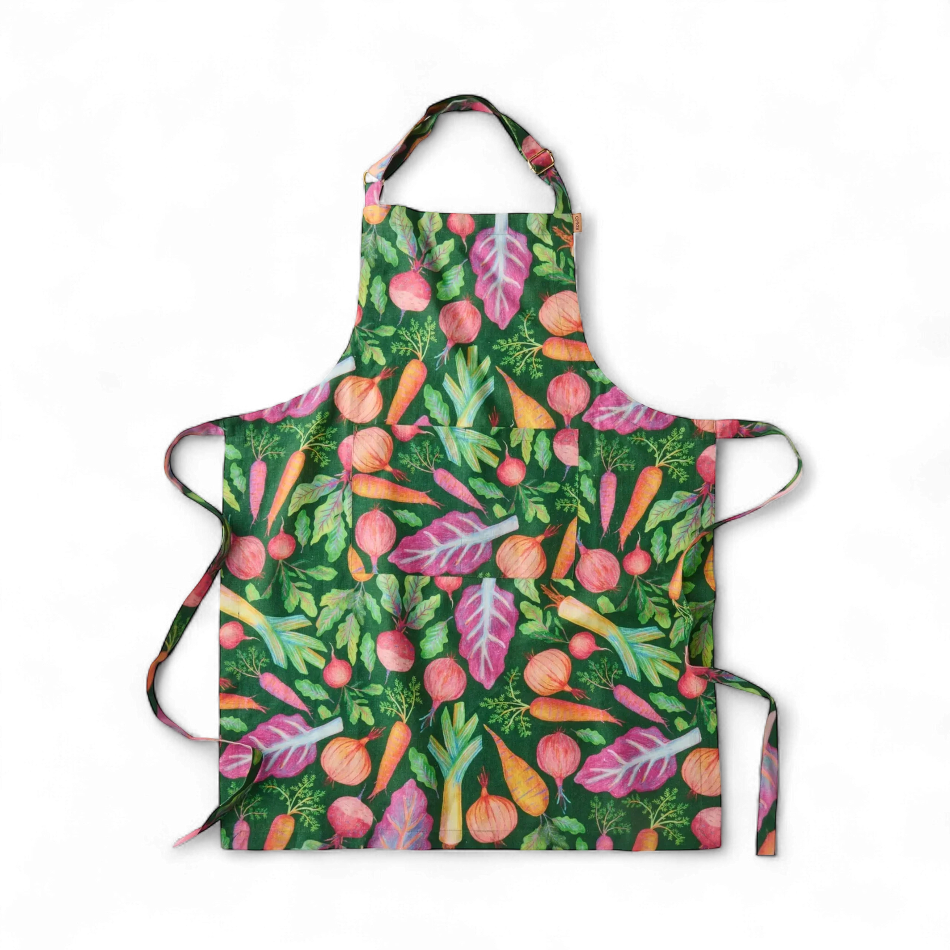 Colorful vegetable print apron with carrots, beets, and onions on green background, perfect kitchen décor
