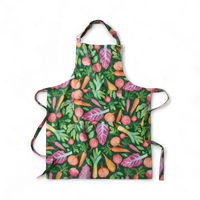 Colorful vegetable print apron with carrots, beets, and onions on green background, perfect kitchen décor