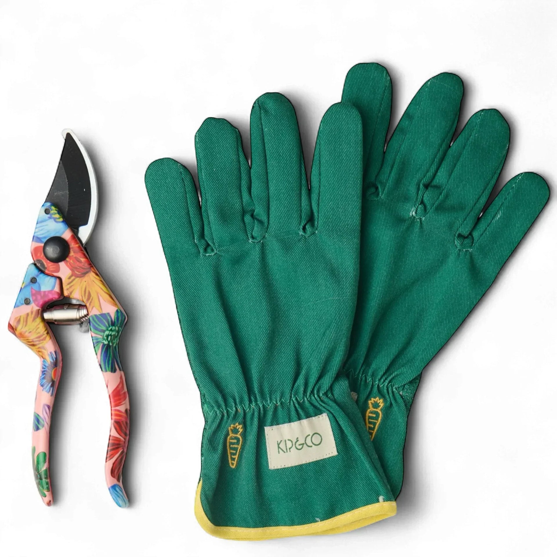 Green gardening gloves with carrot embroidery and floral pruning shears for home garden care