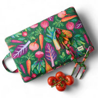 Colorful vegetable-patterned cutting board with matching fork, fresh tomatoes nearby, perfect for kitchen decor