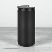 Matte black travel mug with spill-proof lid, modern home accessory for everyday use