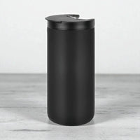 Matte black travel mug with spill-proof lid, modern home accessory for everyday use