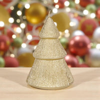 Glittery gold Christmas tree candle for festive home décor with holiday ornaments background