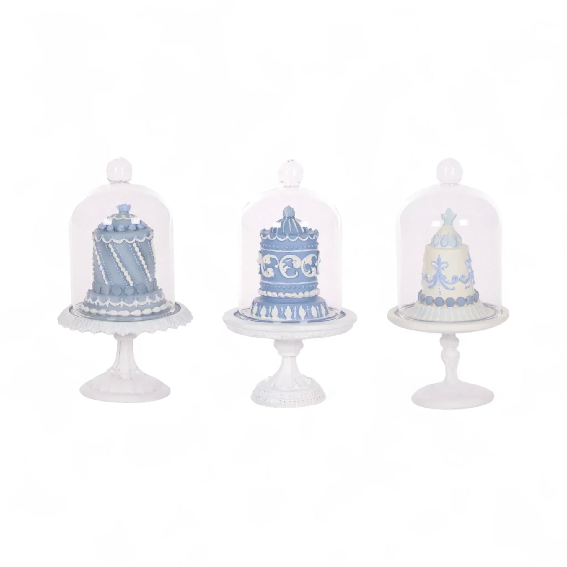 Elegant blue and white decorative cakes under glass domes on ornate stands, perfect for vintage home décor.