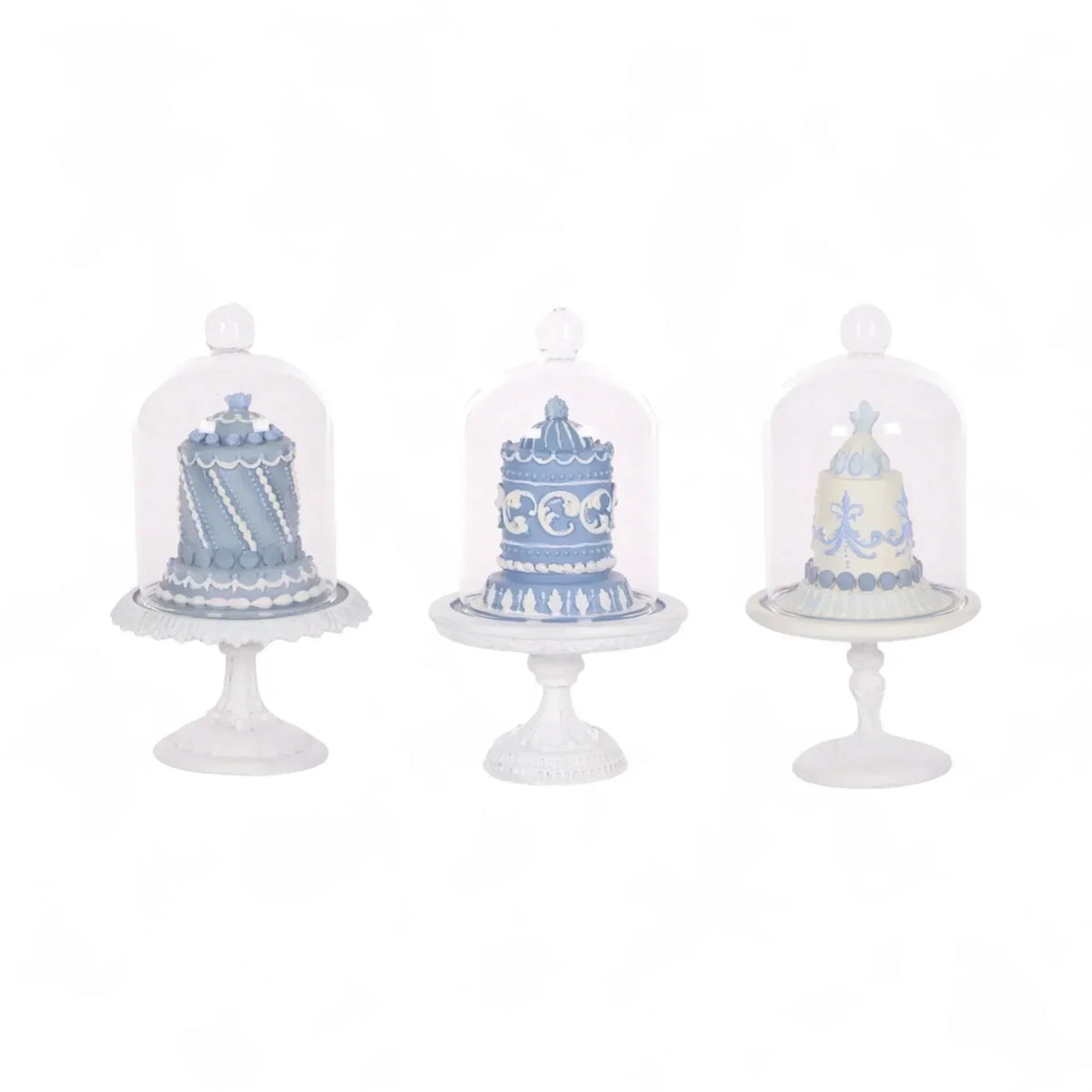 Elegant blue and white decorative cakes under glass domes on ornate stands, perfect for vintage home décor.