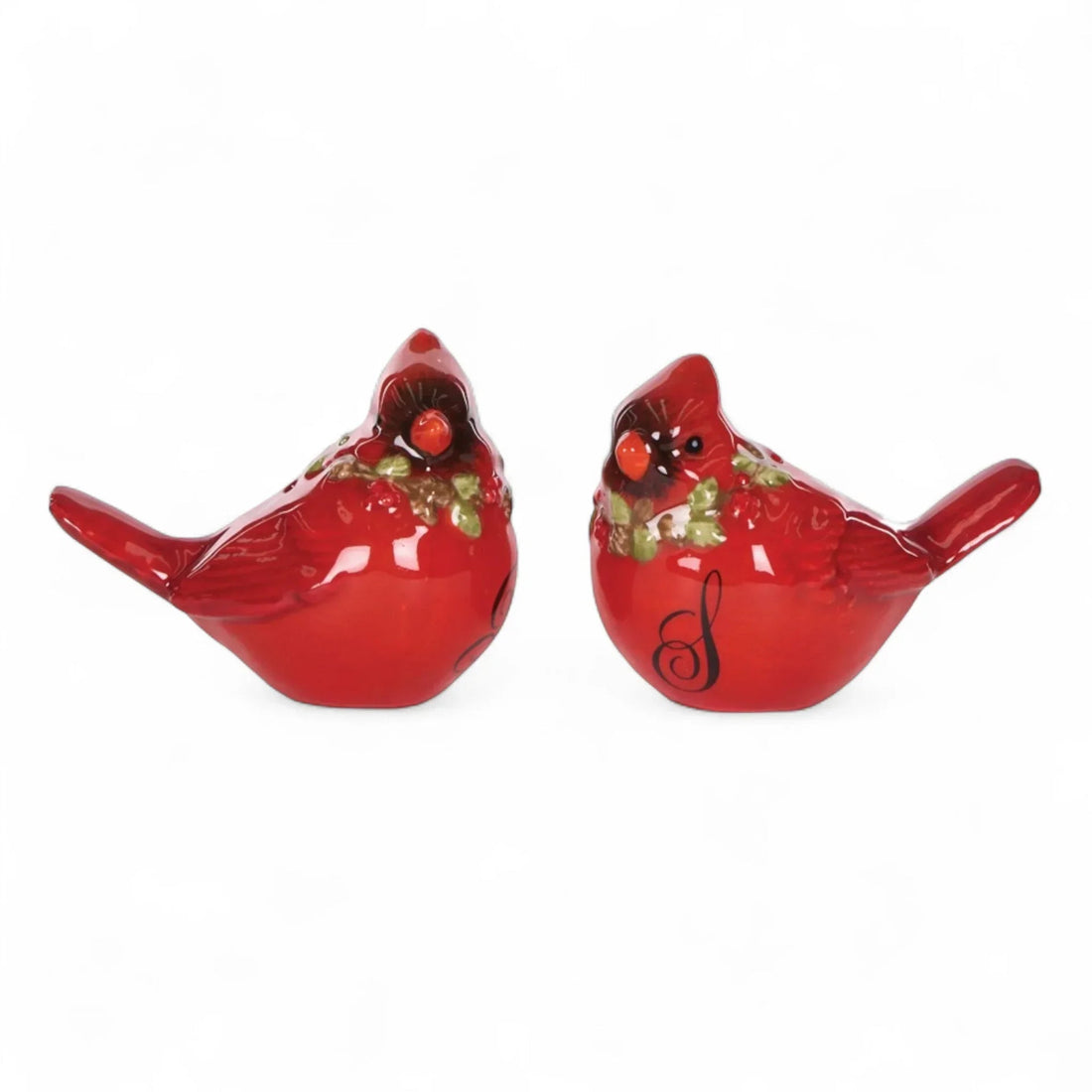 Red cardinal bird figurines with holly, festive home décor accents