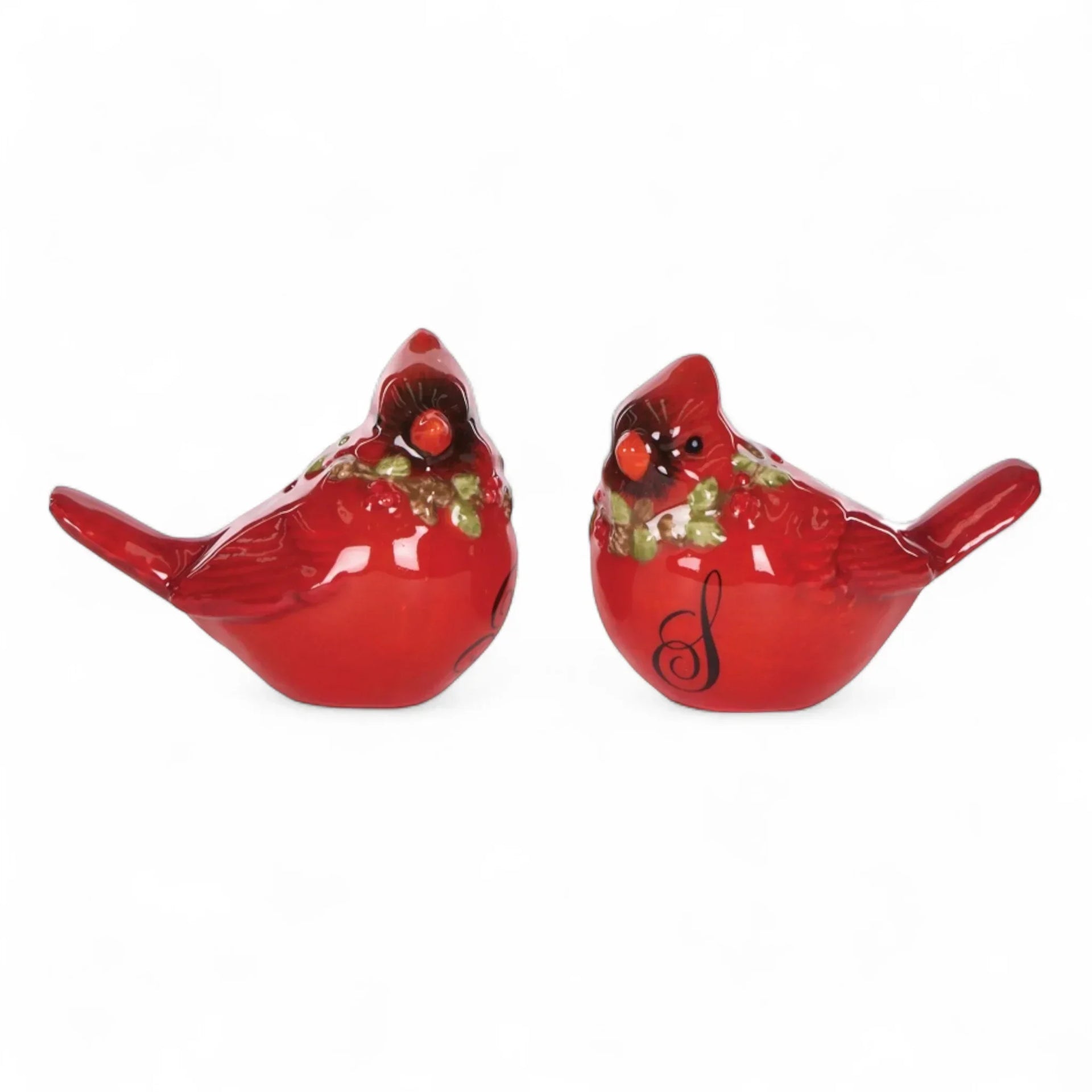Red cardinal bird figurines with holly, festive home décor accents