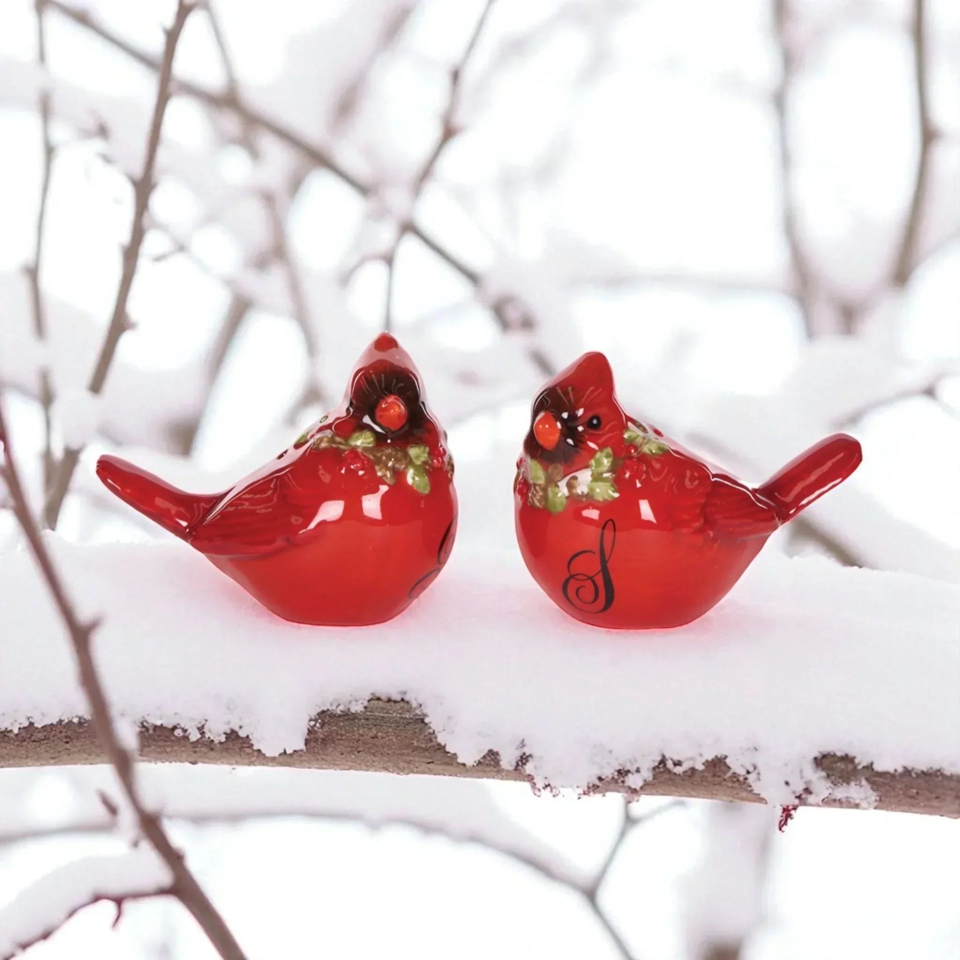 Red cardinal bird figurines with holly, perched on snowy branch for holiday home décor