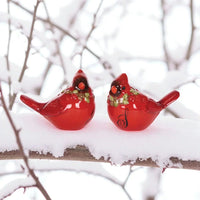 Red cardinal bird figurines with holly, perched on snowy branch for holiday home décor