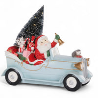 Santa Claus in vintage car with Christmas tree, gifts, and festive animals for holiday home décor