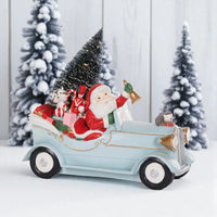 Santa in vintage car with gifts, Christmas tree, and festive animals for holiday décor
