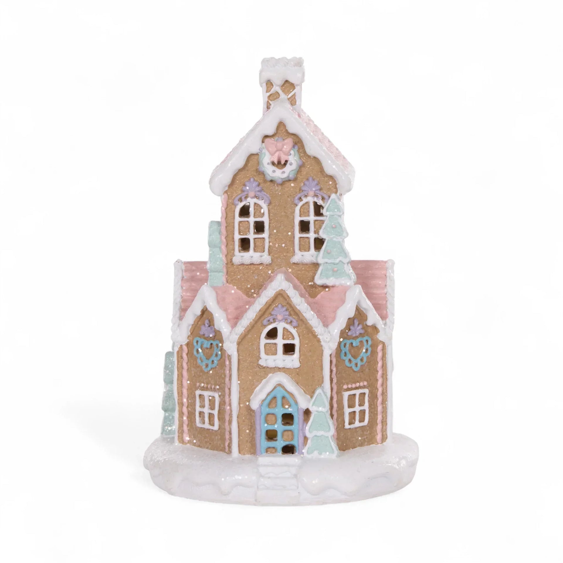 Pastel gingerbread house decoration with glitter, heart details, and snowy roof for festive home décor