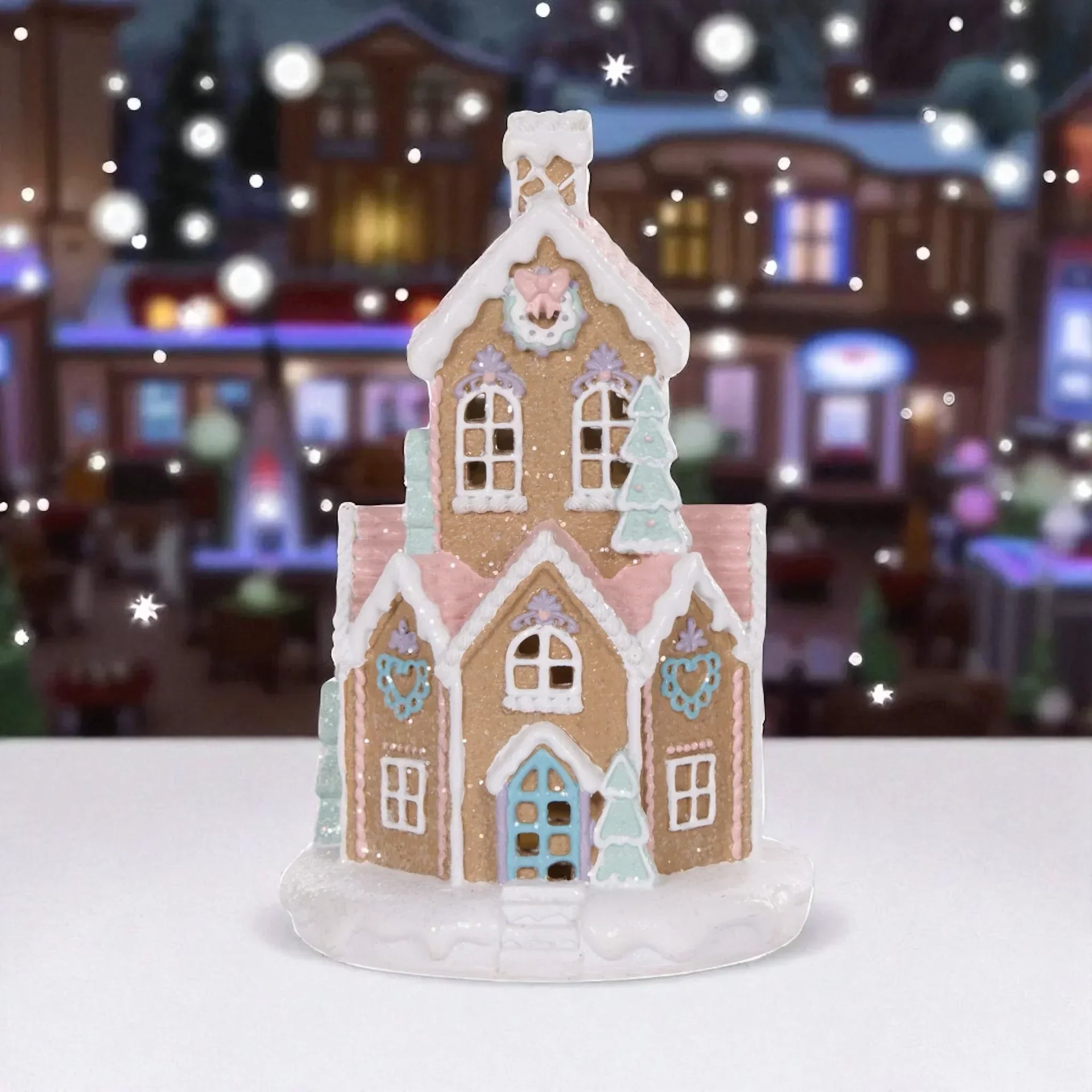 Gingerbread house decoration with pastel icing, festive windows, and snow accents for holiday home décor