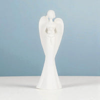 White ceramic angel figurine with wings, holding flowers, elegant home décor accent piece