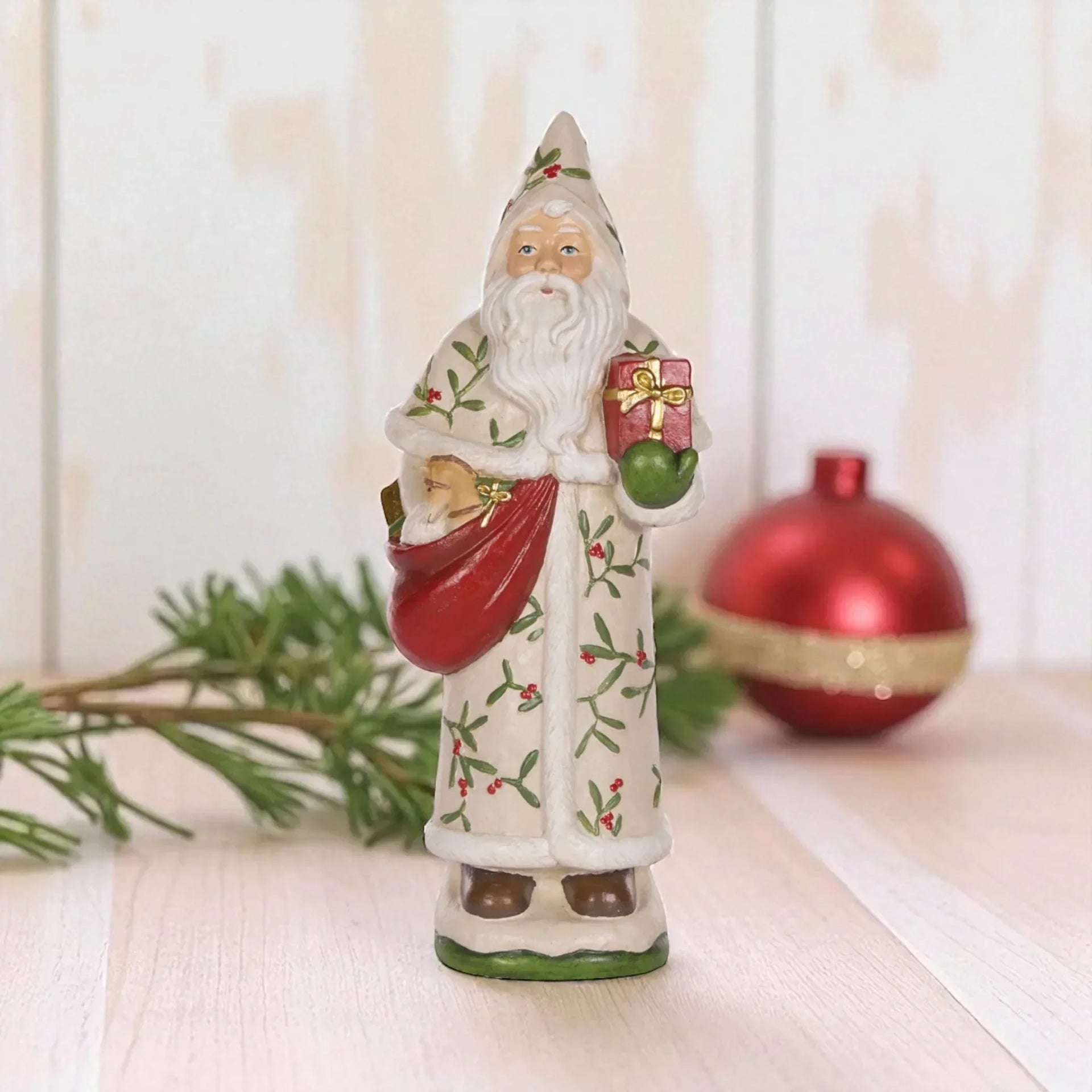 Vintage Santa figurine with mistletoe robe, holding gift and sack, Christmas home decor