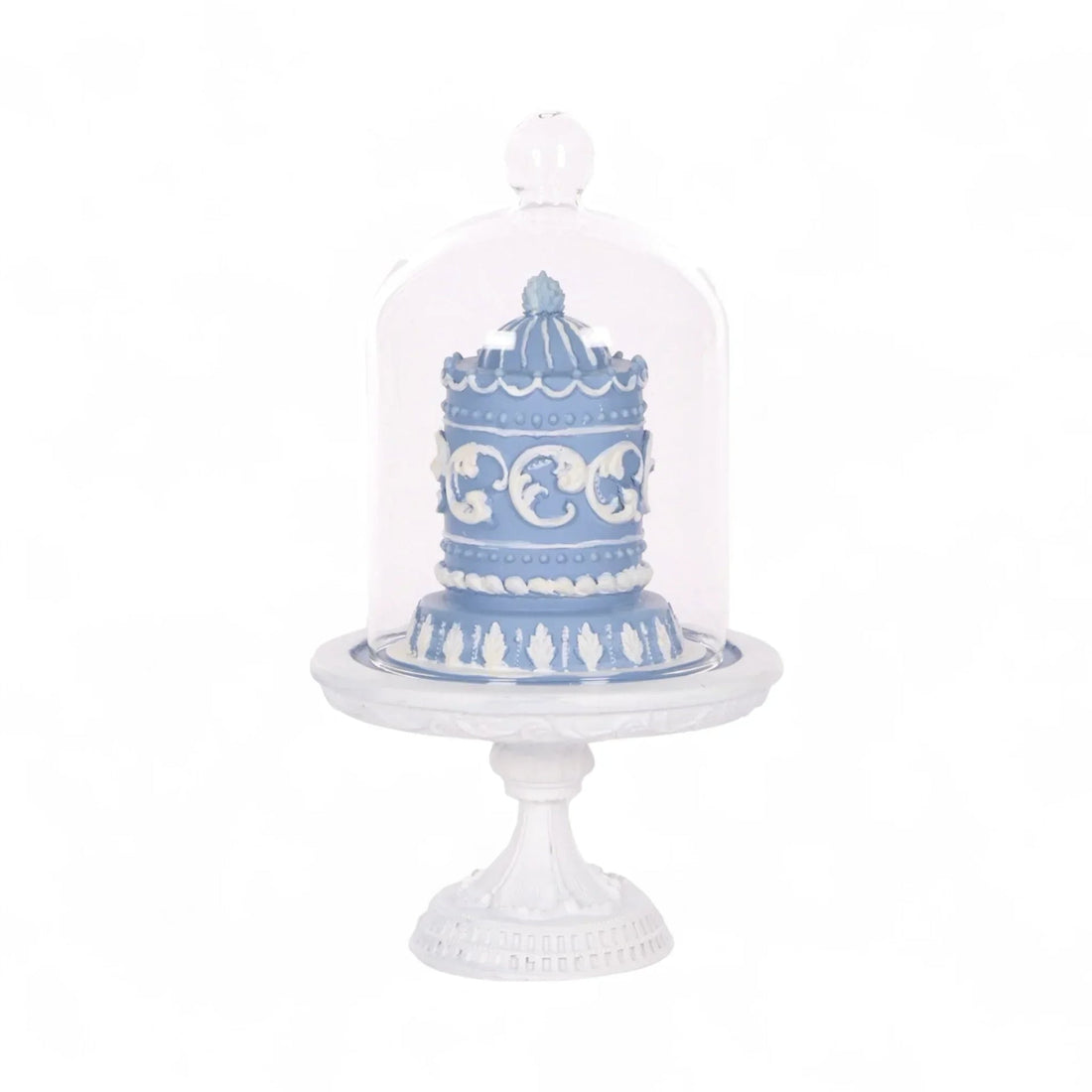 Blue and white decorative cake under glass dome on ornate pedestal, elegant home décor accent piece