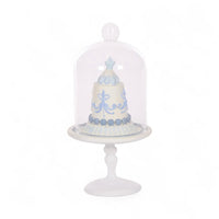 Elegant white cake stand with blue decorative cake under glass dome, perfect for home décor