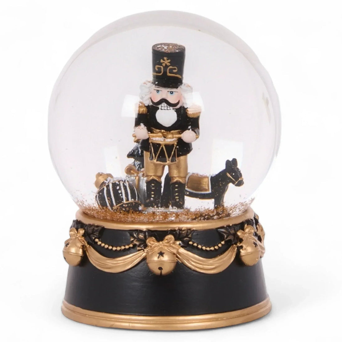 Black and gold nutcracker snow globe with festive holiday decor, perfect for Christmas home décor