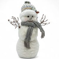 Festive snowman decoration with knit hat, scarf, and berry branches for holiday home décor