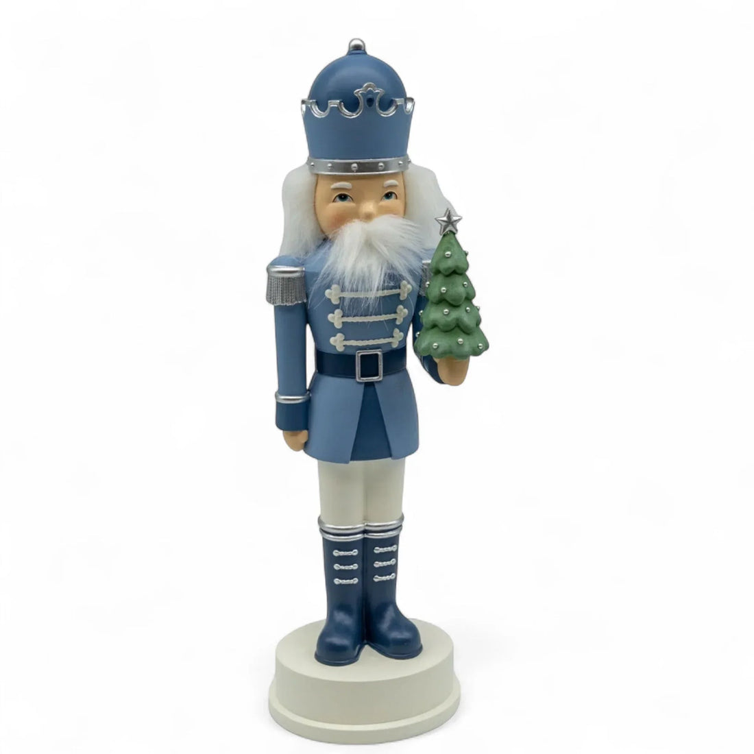 Blue nutcracker holding Christmas tree, festive holiday decor