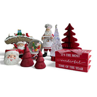 Festive Christmas decor set with Santa figurines, red trees, snow globe, and holiday signs for home styling