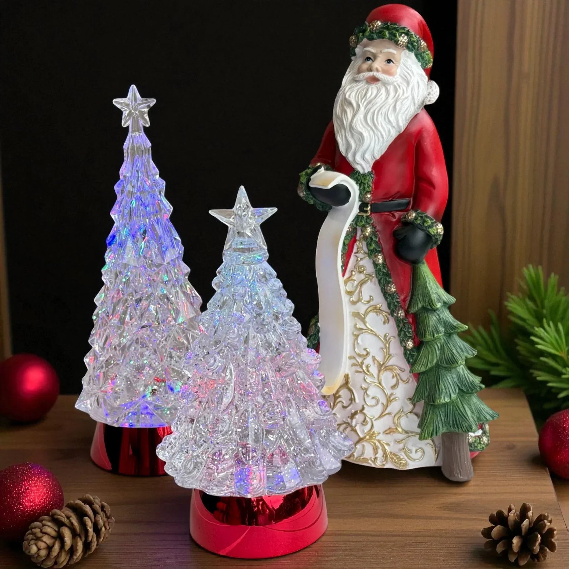 Santa figurine with glowing crystal Christmas trees, festive holiday decor, red ornaments, pinecones