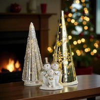 Festive snowman family figurine with glittery and gold Christmas trees, perfect for holiday home décor