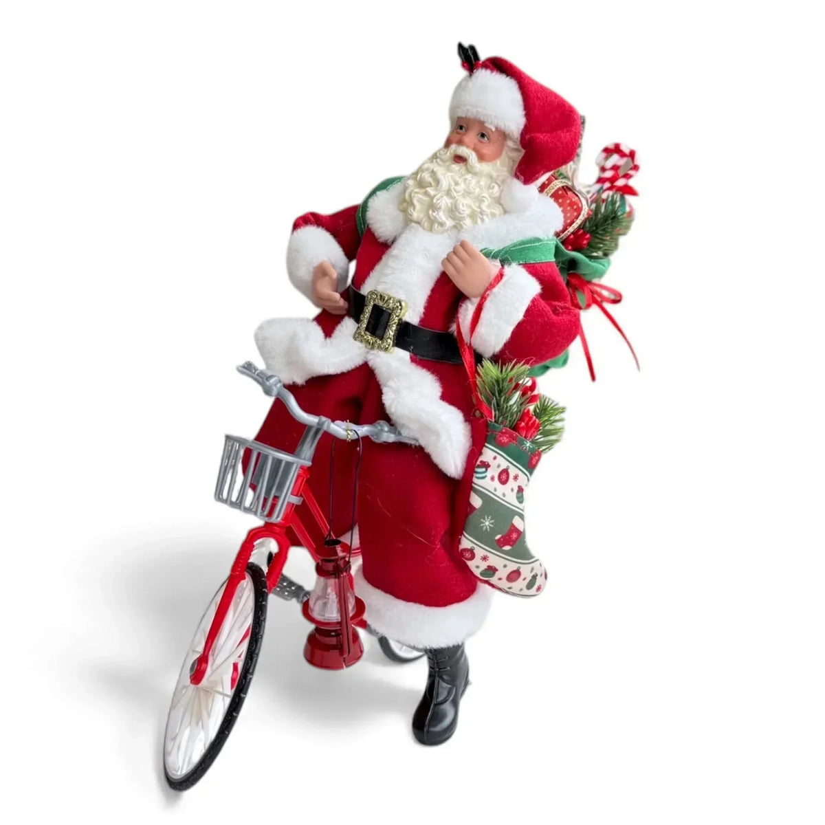 Santa Claus figurine on red bicycle with Christmas stockings and gifts, festive holiday decor