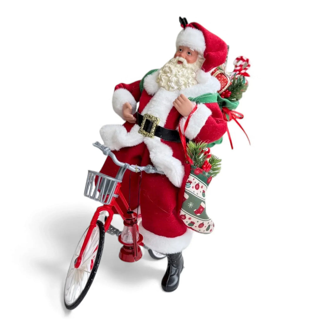 Santa Claus figurine on red bicycle with Christmas stockings and gifts, festive holiday decor