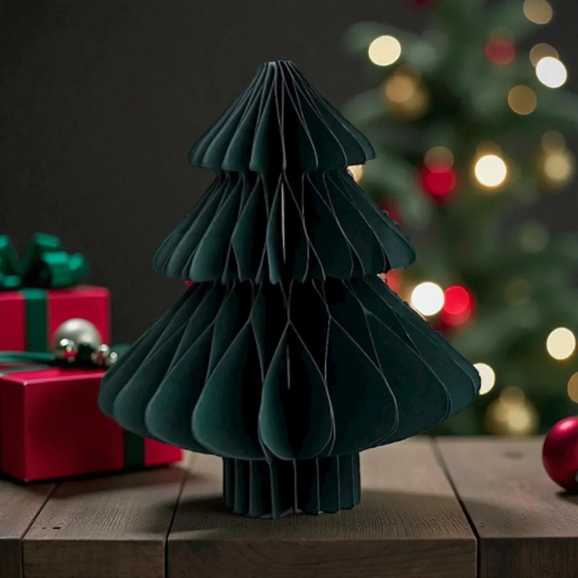 Modern green paper Christmas tree decoration with festive lights and gifts, perfect for holiday home décor