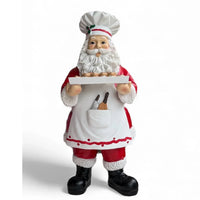 Chef Santa figurine holding tray of cookies, festive holiday home decor with apron and hat