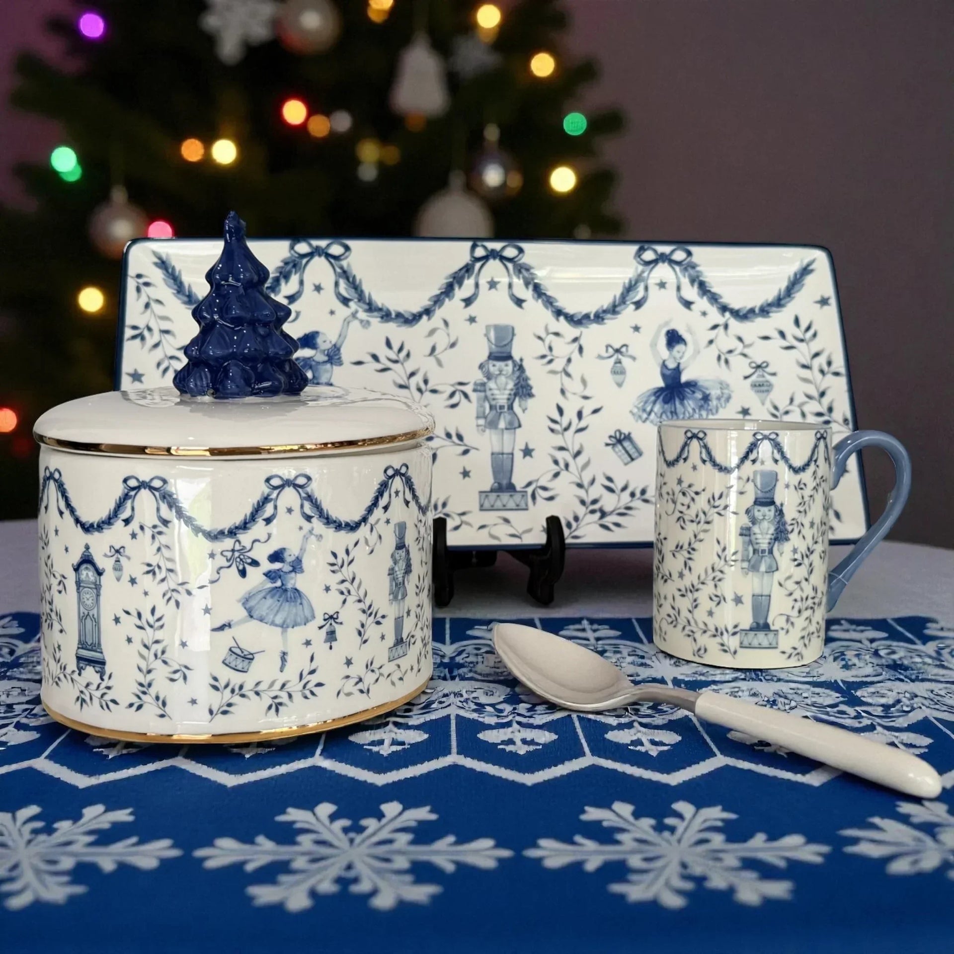 Blue and white holiday-themed ceramic set with nutcracker, ballerina, and Christmas tree designs
