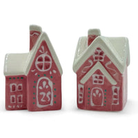 Charming red ceramic house figurines with white roofs, perfect for home décor and festive displays.