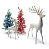 White ceramic reindeer figurines with blue and pink flocked Christmas trees, festive home décor