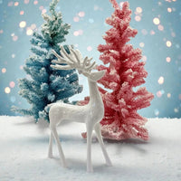White ceramic reindeer figurine with blue and pink flocked Christmas trees on snowy base, holiday home decor