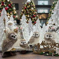Festive Christmas display with glitter owls, snowmen, Santa, and decorated trees for holiday home décor