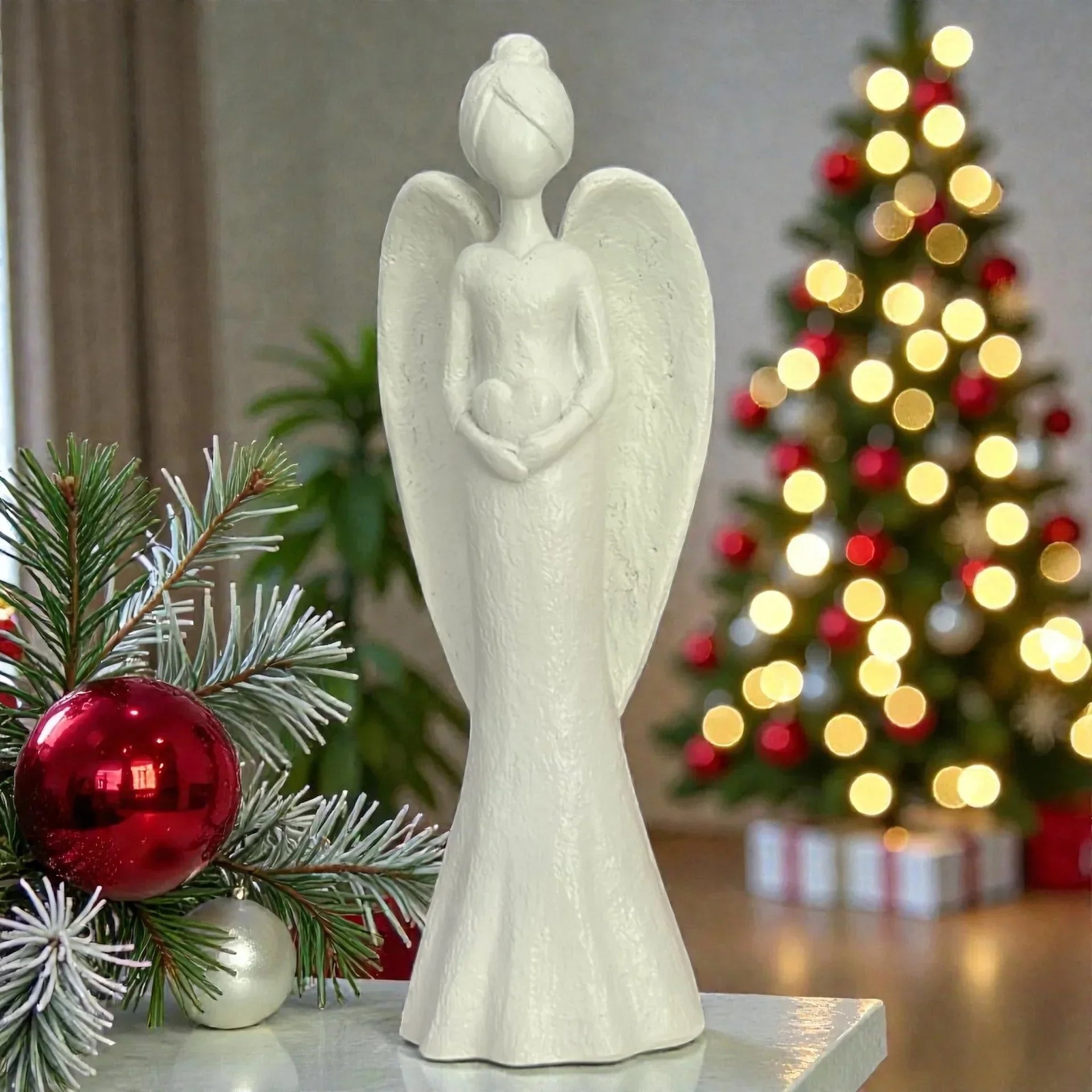 White angel figurine with Christmas tree and red ornaments, festive home décor