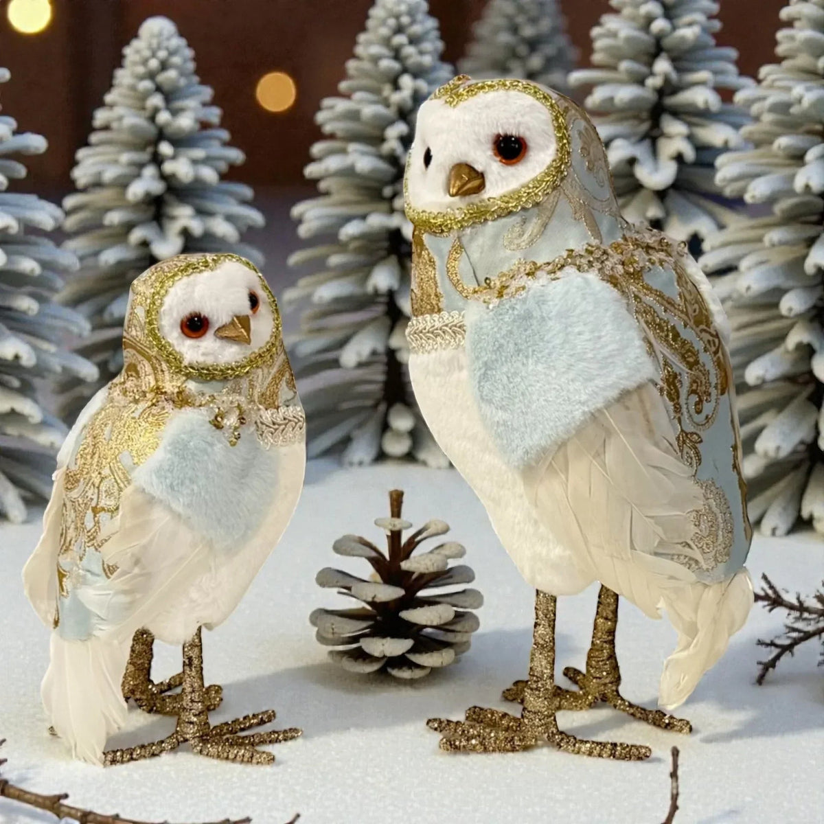 Elegant white owl ornaments with gold accents, perfect for festive home décor and winter holiday displays.