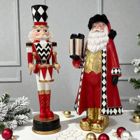 Red and black harlequin Santa and nutcracker figurines with gold accents, festive holiday decor