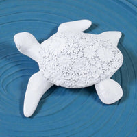 White ceramic turtle sculpture with floral shell design, coastal home décor accent piece