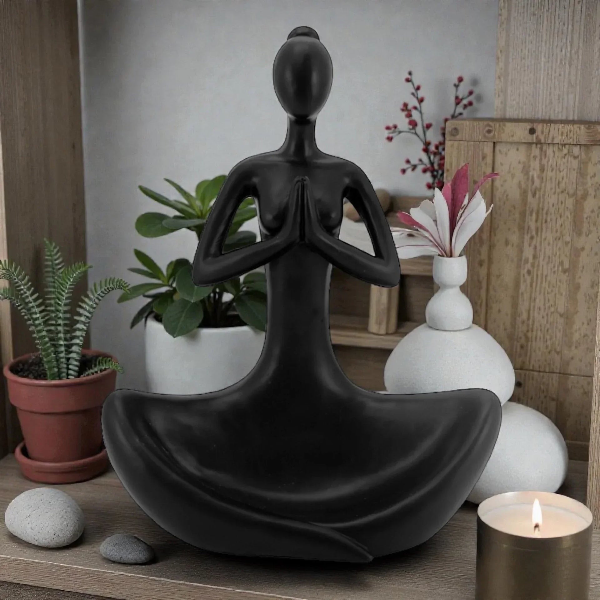 Black meditation statue for zen home décor with plants and candle