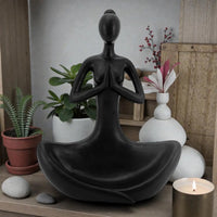 Black meditation statue for zen home décor with plants and candle