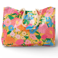 Vibrant floral tote bag with rope handles, featuring pink, blue, and orange blooms on yellow background