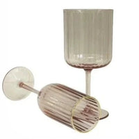 Elegant ribbed wine glasses in soft pink hue, perfect for home décor and entertaining