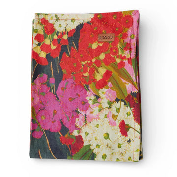 Vibrant floral tea towel with red, pink & white blossoms, perfect for home décor and kitchen use.