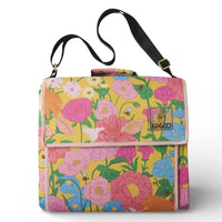 Vibrant floral picnic blanket with pink, blue, and yellow blooms, bees, ladybugs, and adjustable black strap for outdoor use.