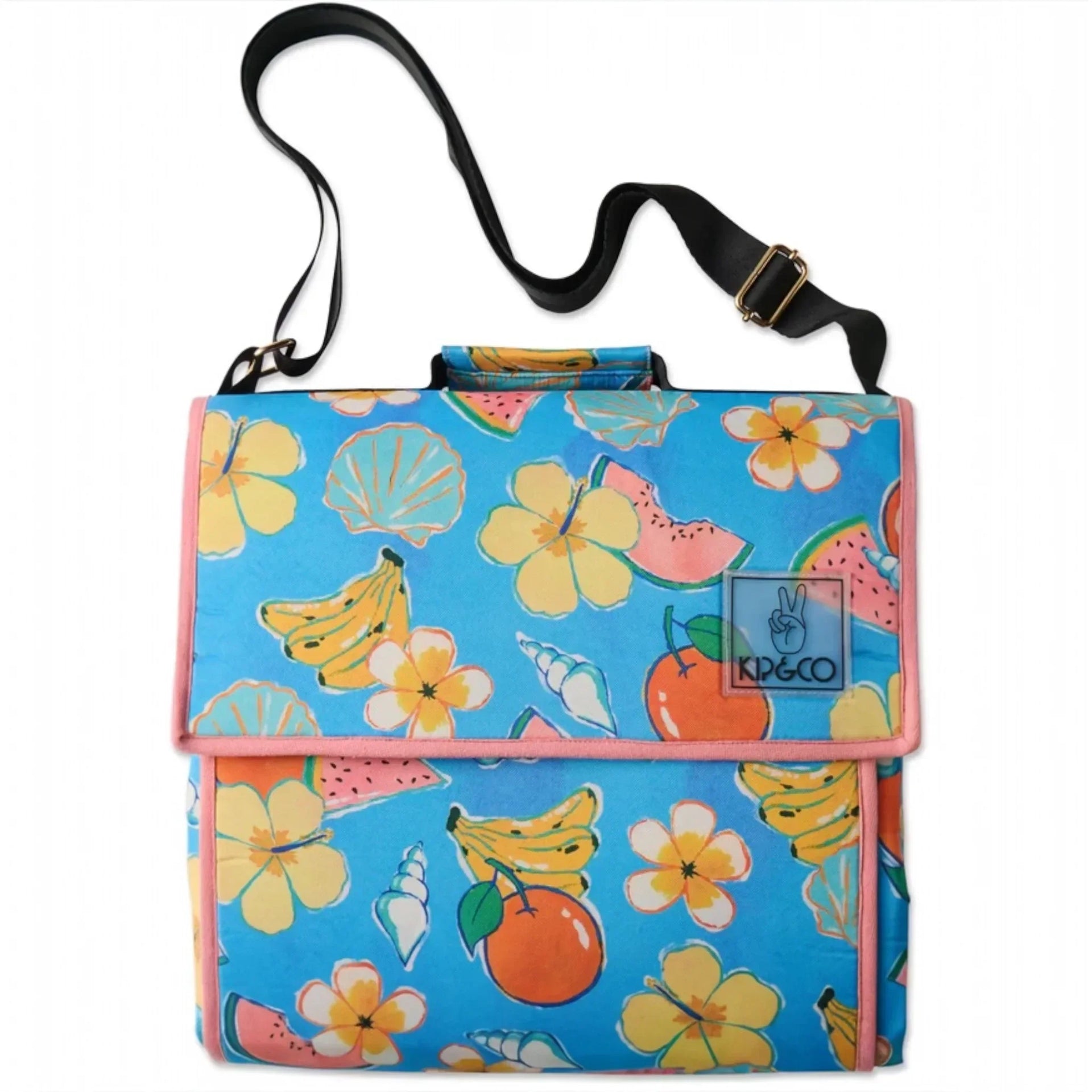 Tropical fruit and flower print picnic blanket with carry strap, perfect for outdoor gatherings and beach days.